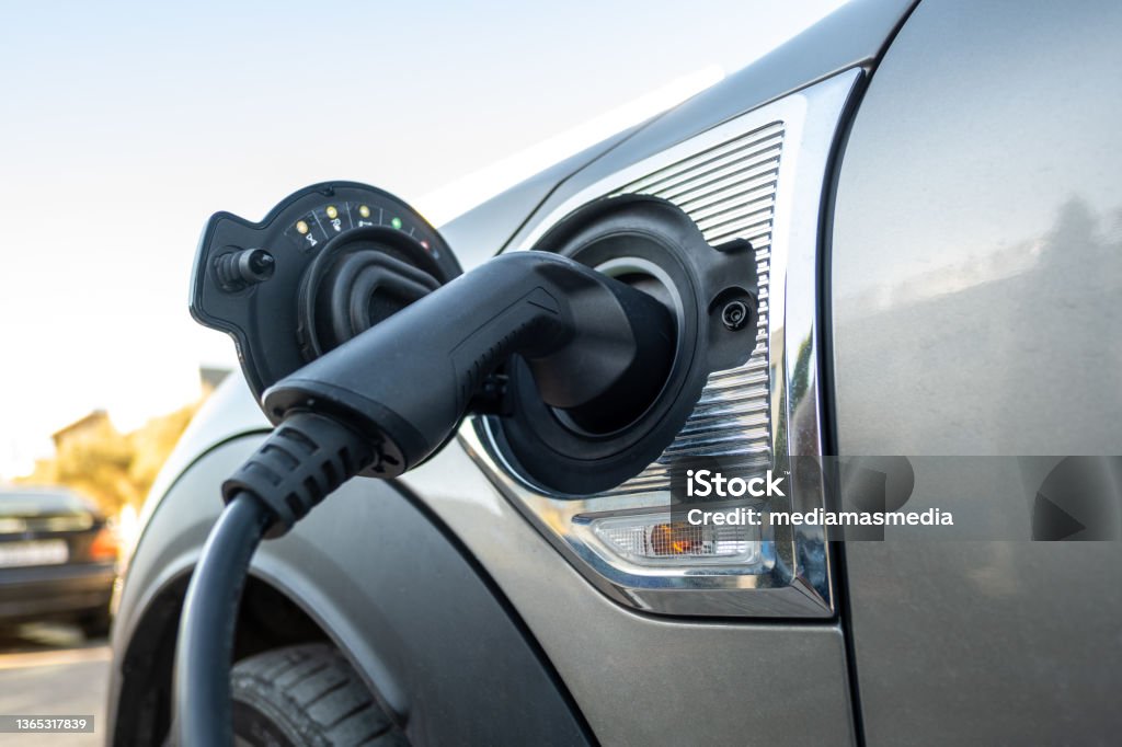Electric car charging at power station Electric Vehicle Stock Photo