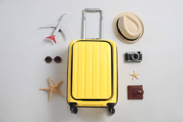 istock Flat lay composition with suitcase and travel accessories on grey background. Summer vacation 1365318088