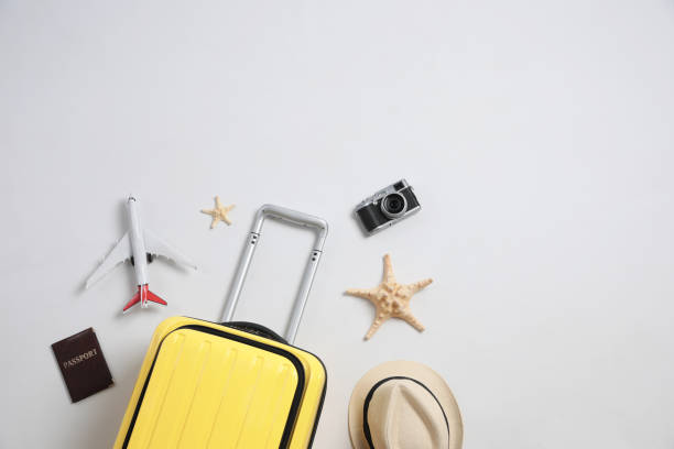 istock Flat lay composition with suitcase and travel accessories on grey background, space for text. Summer vacation 1365318116