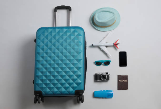 istock Flat lay composition with suitcase and travel accessories on grey background. Summer vacation 1365318268