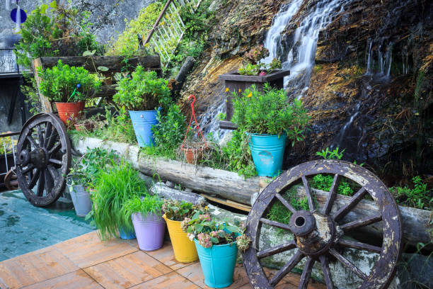 Beautiful garden with small waterfall and blooming flowers.
