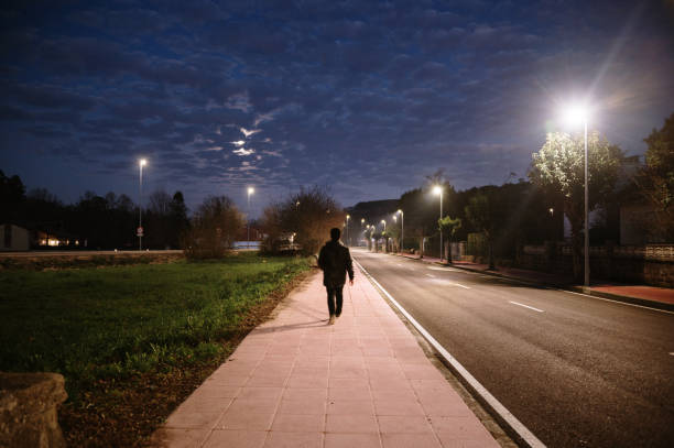 istock Silhouette of a man walking at night 1365321756