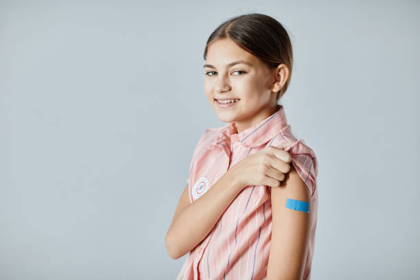 istock Smiling Girl with Vaccine Patch 1365322603