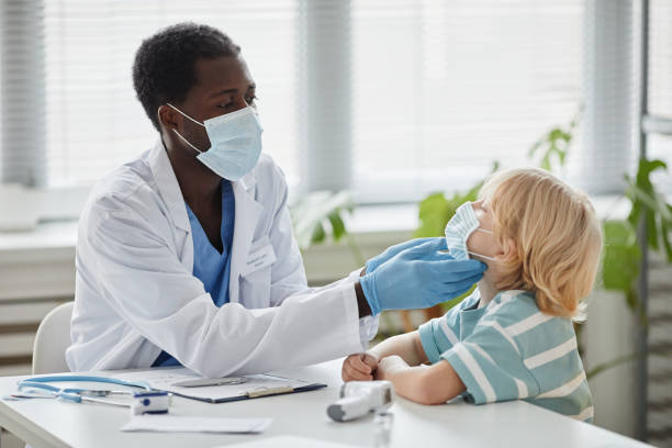 istock African American Doctor Examining Little Boy 1365322675