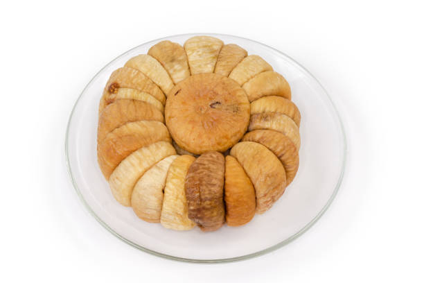 istock Dried figs laid out in a circle on glass saucer 1365322862