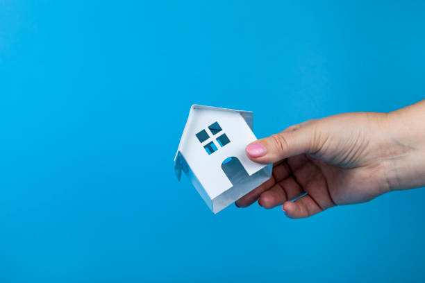 istock Hand with a toy house. 1365327782