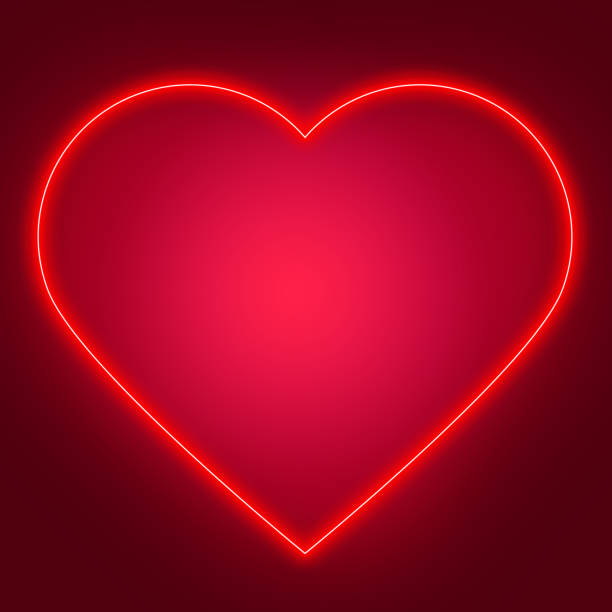 istock A large, neon, glowing red heart on a purple background. 1365328991
