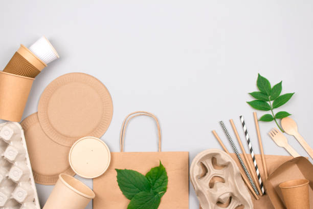 istock Eco-friendly tableware - kraft paper food packaging on light gray background with copy space. Street food paper packaging, recyclable paperware, zero waste packaging concept. Flat lay 1365329650