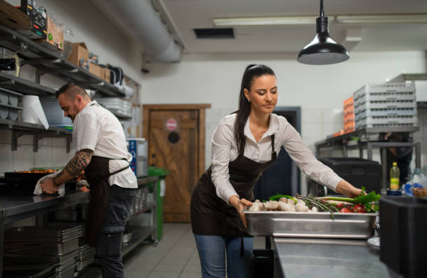 istock Chef and cook working on their dishes indoors in restaurant kitchen. 1365330578