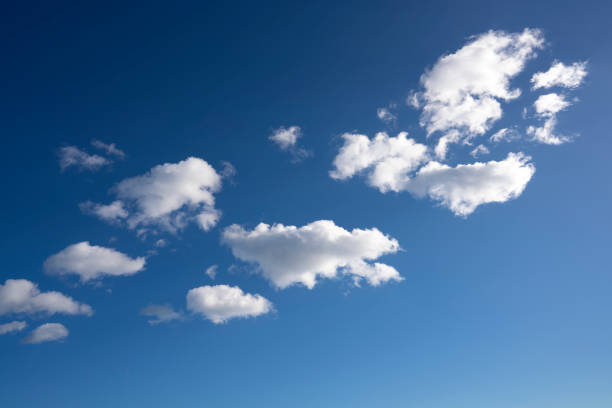 istock Blue sky with summer cumulos clouds background 1365331185