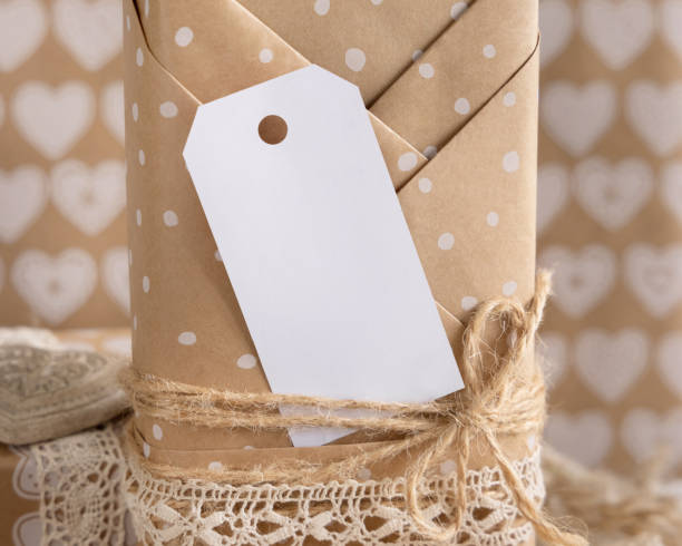 istock Valentines present with blank gift tag and hearts close up, Rustic label Mockup 1365331790