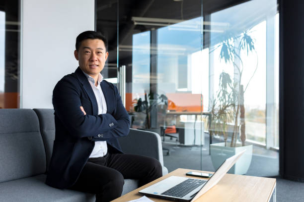 istock Successful businessman boss happy looking at camera and smiling, working in modern office 1365334479