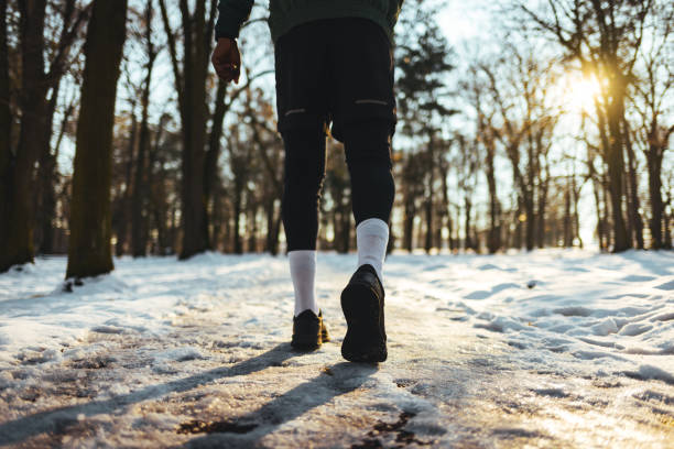 Young African man exercising in the forest on winter day