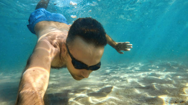 istock Man swimming under the water, Mediterranean sea 1365337678