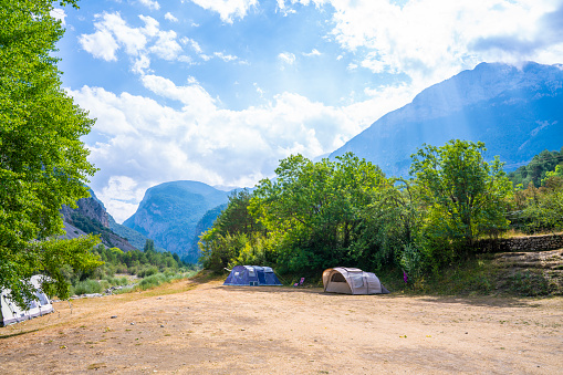 Camping concept in Pyrenees idyllic valley with magic light in beautiful nature landscape