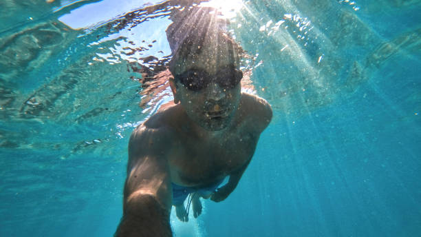 istock Man swimming under the water, Mediterranean sea 1365340084