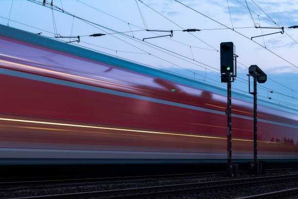 istock Express train passes a signal showing green. 1365341169