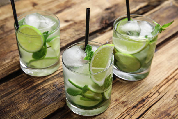 istock Delicious mojito and ingredients on wooden table 1365345814