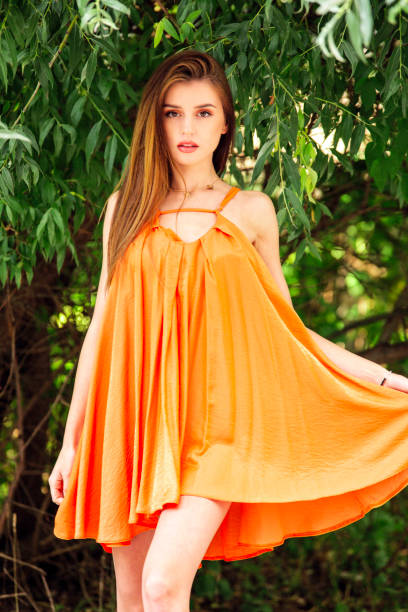 woman with modern orange dress on vacation