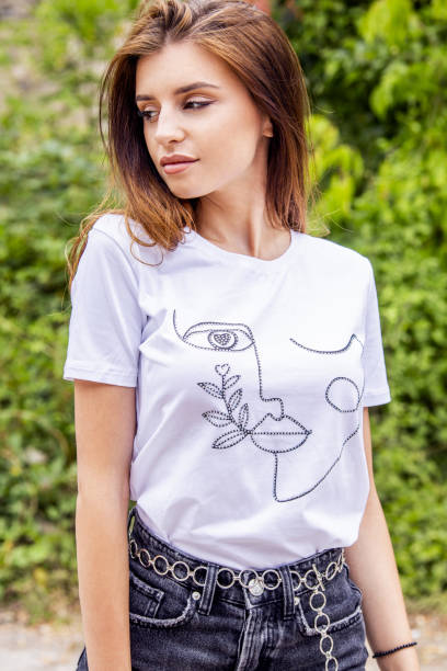 istock woman with white t-shirt posing . Fashion look 1365347330