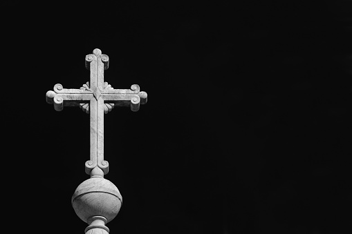 Christian religion. Holy cross at the top of monument erected in Tiber Island in Rome and erected in 1869