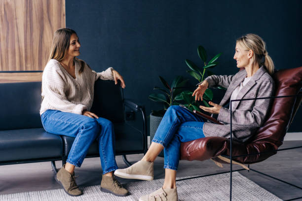 istock Two modern stylish women are sitting in the office discussing ideas and implementation of plans. 1365349094