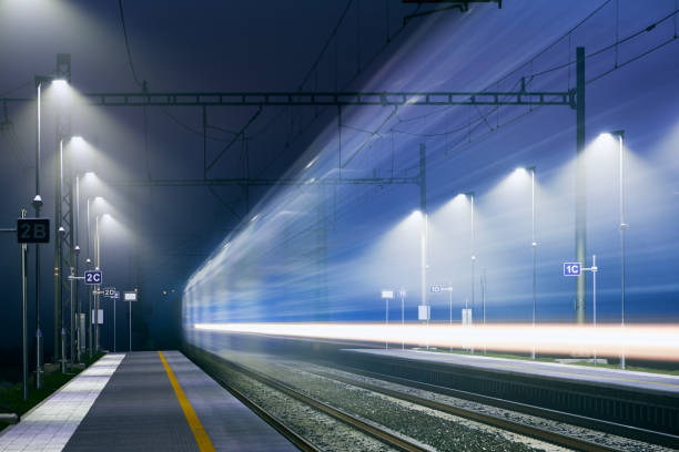istock Light trail of passenger train at railroad station 1365349694