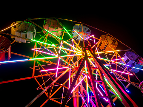 bottom up view  colorful ferris wheel with lighting at night