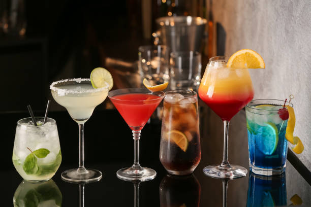 istock Different delicious cocktails on black table in bar 1365351486