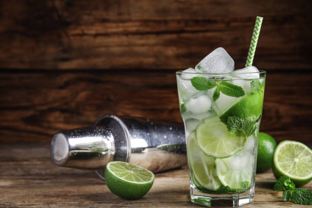istock Delicious mojito and ingredients on wooden table. Space for text 1365351591