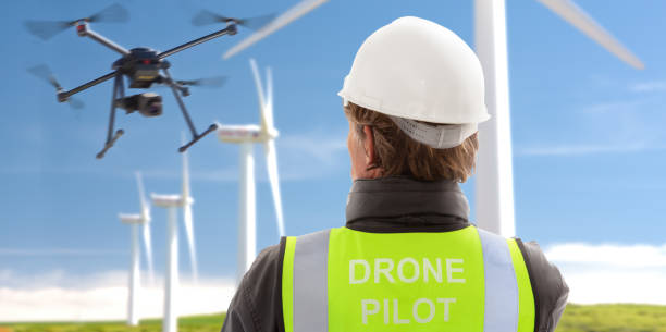 professional drone operator engineer inspecting wind turbines - fotografia de stock