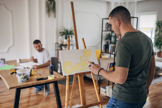 istock Male twin artists working 1365353232