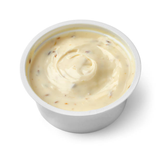 istock Plastic dish with low fat Goats cream cheese and cumin close up on white background 1365356990