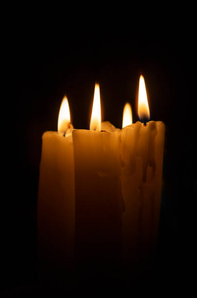 istock Burning wax candles on a dark background. copy space. 1365360194