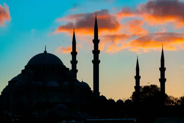 Silhouette of Suleymaniye Mosque. Mosque at sunset with clouds background photo. Ramadan, kandil, iftar, laylat al-qadr or islamic background photo.