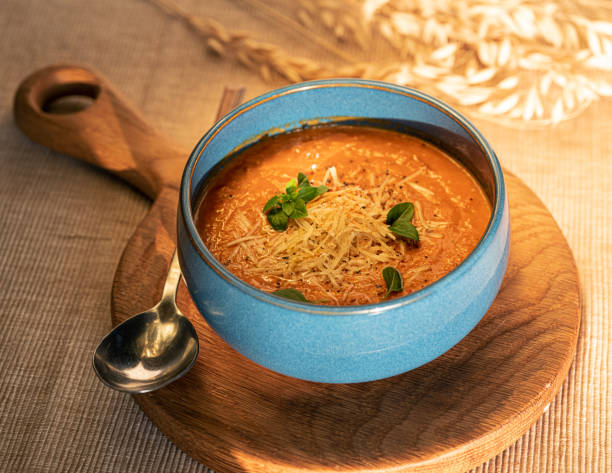 istock Vegetable soup in a blue bowl with wheat ears. Top view 1365360516