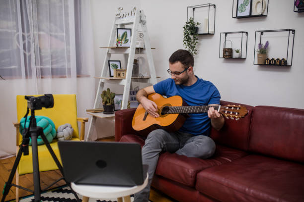 istock Man giving guitar lesson via streaming 1365362123