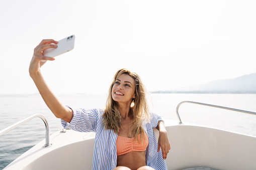 Photo of a smiling woman taking a selfie during the boat ride