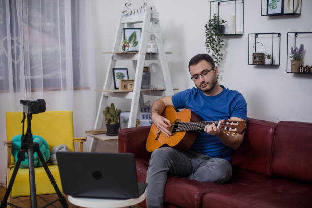 istock Man giving guitar lesson via streaming 1365362477