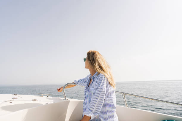 Photo of a young woman enjoying a summer day on the boat
