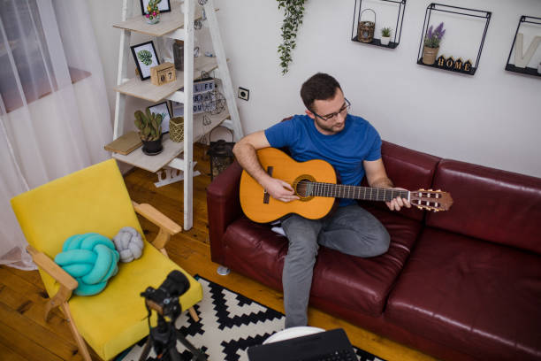 istock Man giving guitar lesson via streaming 1365363171