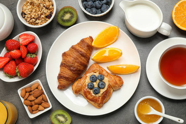 istock Delicious pastries and orange slices on grey table, flat lay. Buffet service 1365365451