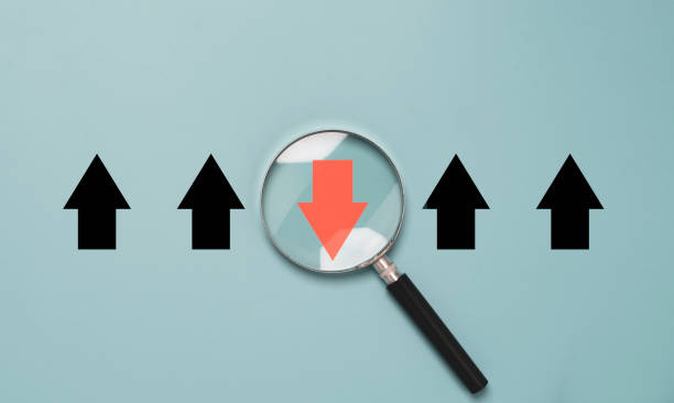 istock Red arrow inside of magnifier glass and different direction from white arrow for focus business disruption and technology transformation concept. 1365365569
