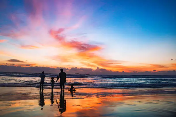 Photo of Family with two children walking on beach in Sri Lanka at sunset