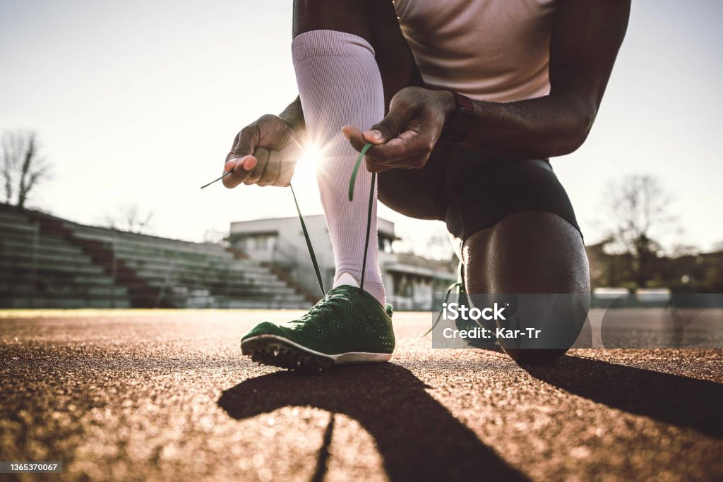 Closeup of man trying jogging shoes - Male athlete run on running track in a stadium - Sport lifestyle concept Shoe Stock Photo
