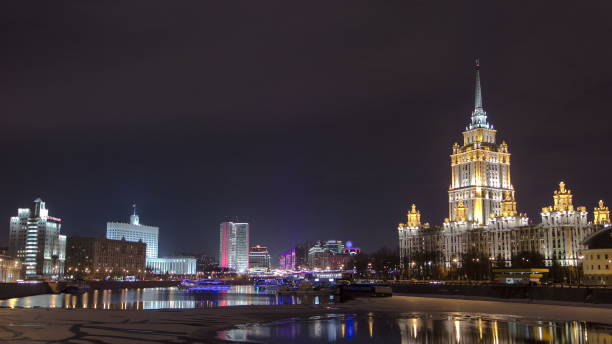 istock Hotel Ukraine winter night timelapse. Seen as reflected in the Moscow River 1365370197