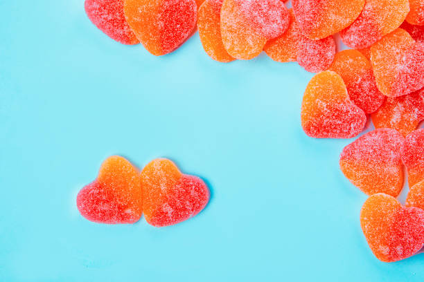istock Candy hearts, flat lay on cyan background 1365371178