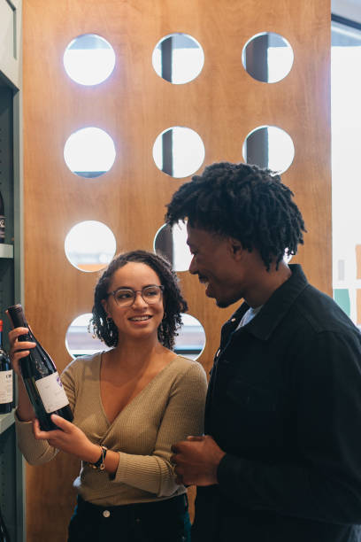 istock Couple shopping for wine 1365371368