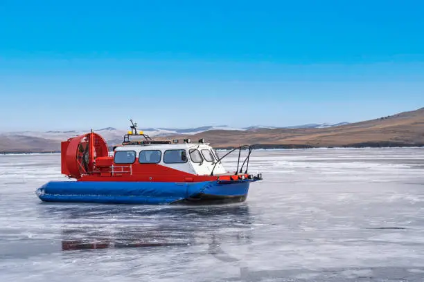 Photo of Hovercraft - Khivus on Lake Baikal. Khivus, airboat, winter transport extreme. Hovercraft sliding fast on the surface of the transparent frozen Lake Baikal, beauty of nature.