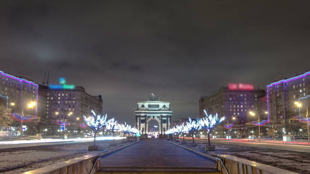istock Triumphal arch in Moscow with Christmas illuminations at night timelapse 1365376572